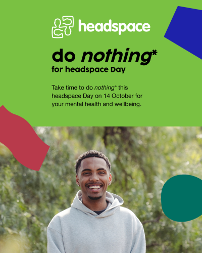 Green headspace Day graphic featuring the headspace logo, the headline “do nothing* for headspace Day” and text encouraging people to take time to do nothing on 14 October for their mental health and wellbeing. A smiling young man in a grey hoodie is pictured outdoors among trees.