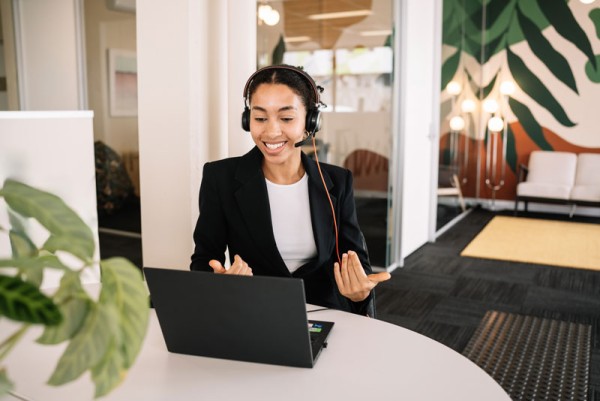 girl with headset talking on laptop