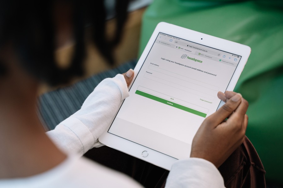 A person holding an iPad, using it to create a headspace account