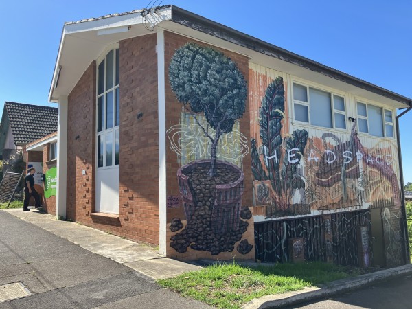 street image of headspace Katoomba with a young person entering and a larger logo saying welcome here superimposed 