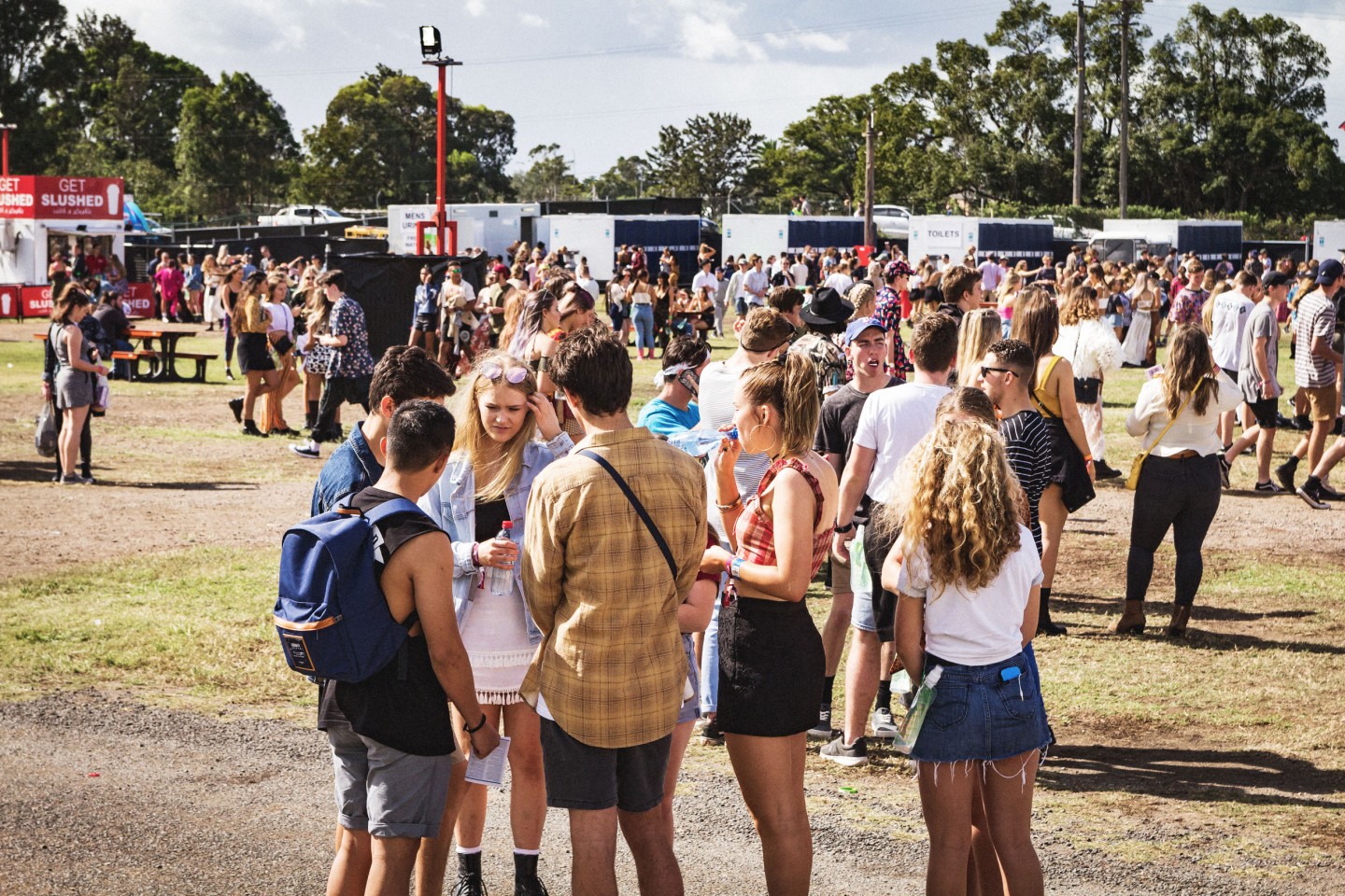 A group of young people standing together at a music festival
